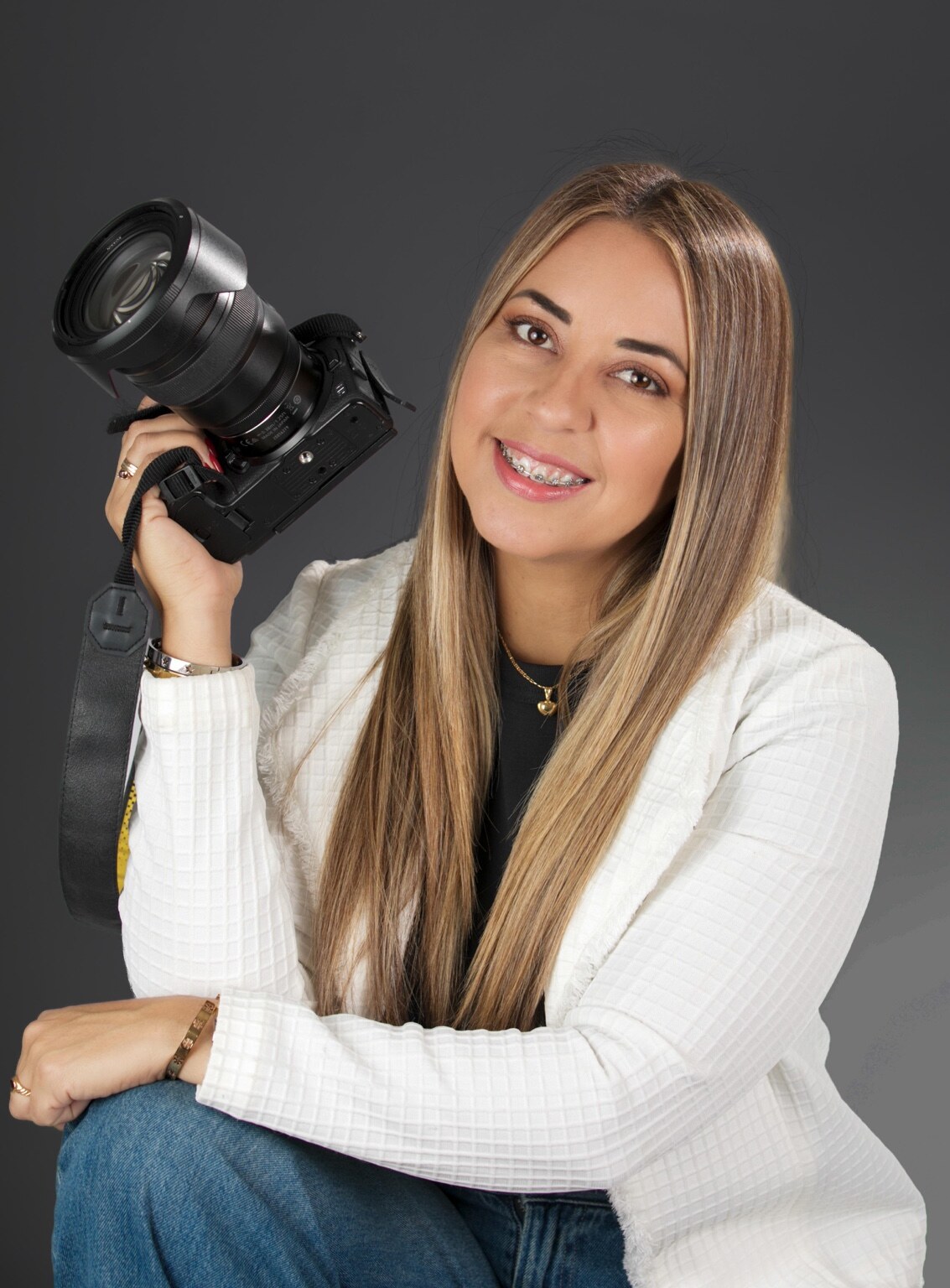 Aneiram Annie Garcia seated with her camera