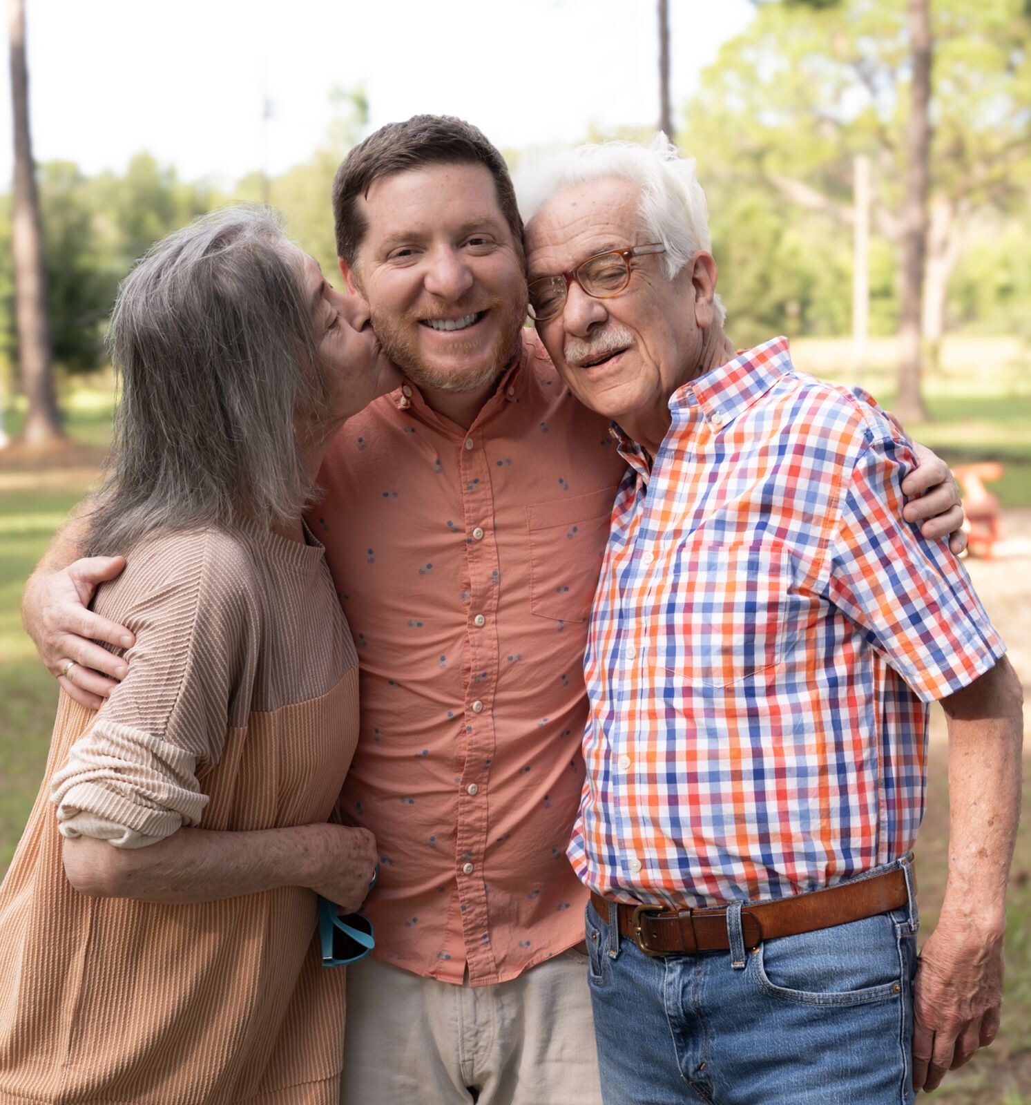 Three generations sharing an affectionate family moment outdoors