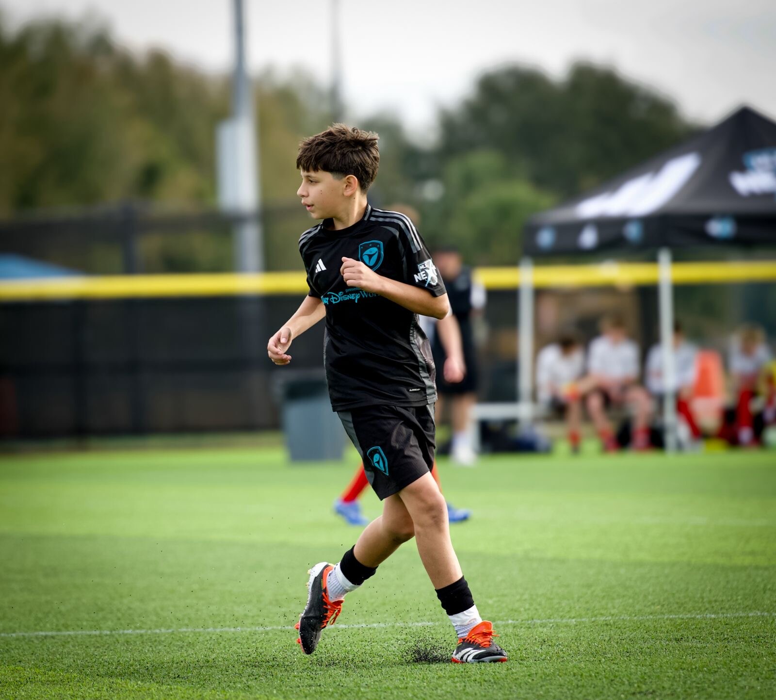 Youth soccer player moving across the field during a match